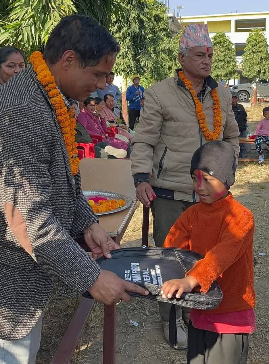 student receiving donation from resham firiri nepal manager dipak pangeni